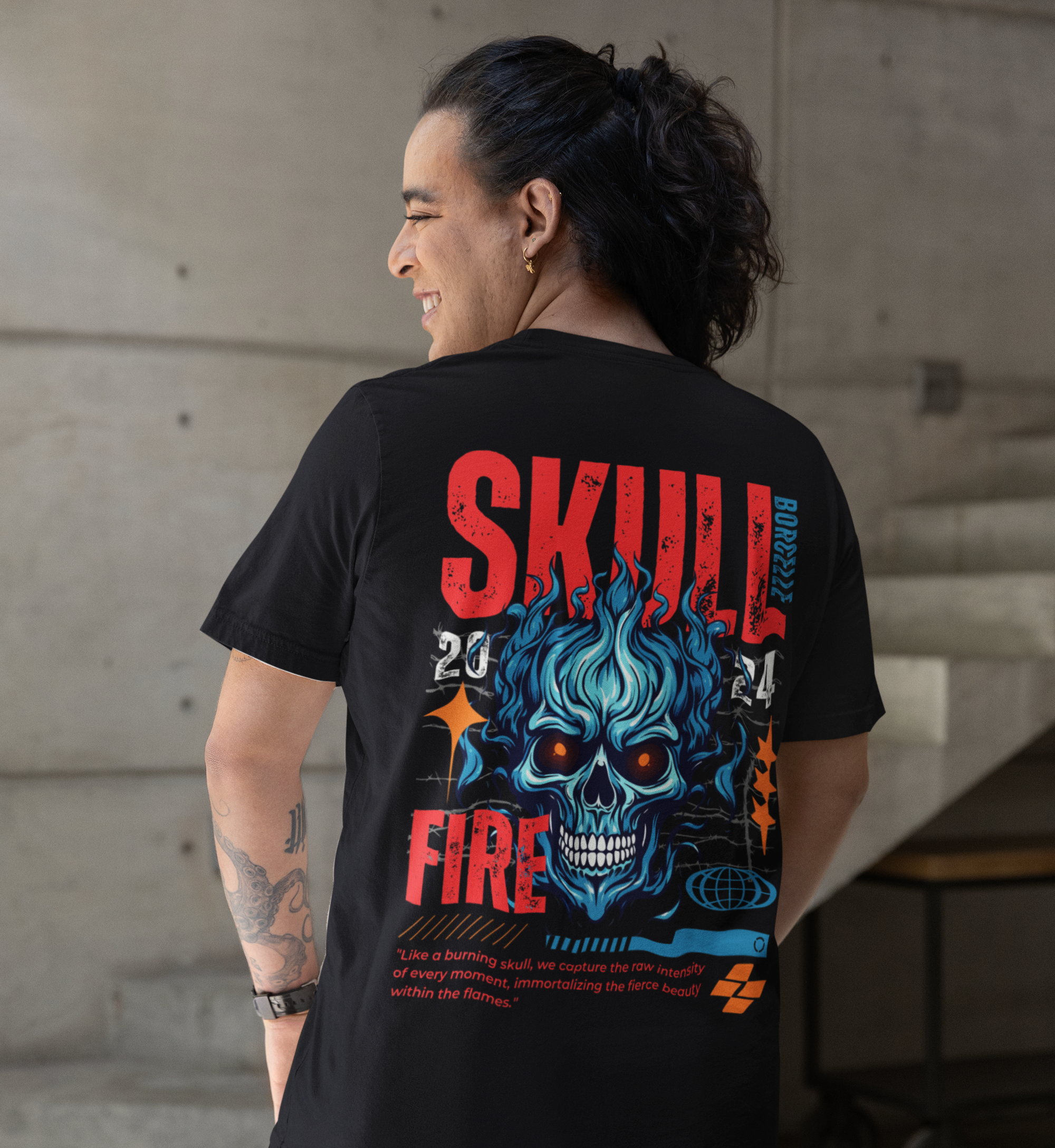 Person wearing a black t-shirt with a colorful skull design on the back, standing in an indoor setting.