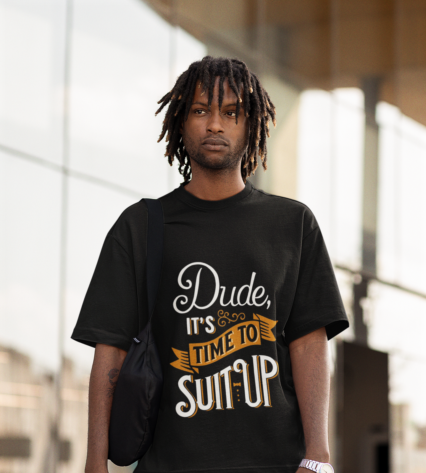 Man wearing a black t-shirt with text, standing outdoors.